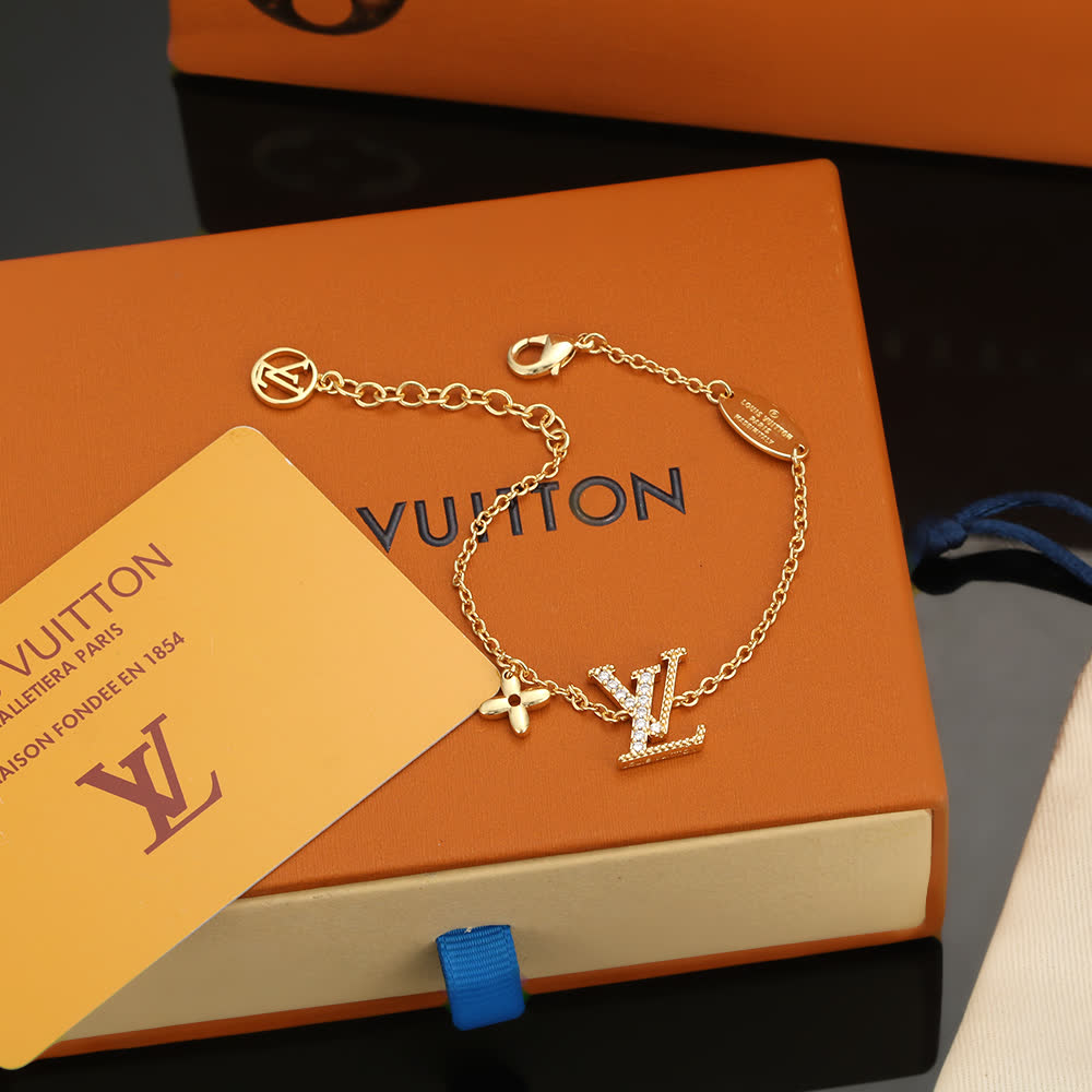 Louis Vuitton Gold Tone Bracelet with Monogram Charm Louis Vuitton Gold Tone Bracelet with Monogram Charm